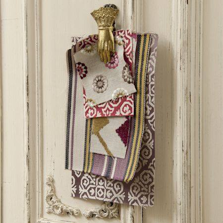Photo showing fabric samples  hanging from a clip on a door
